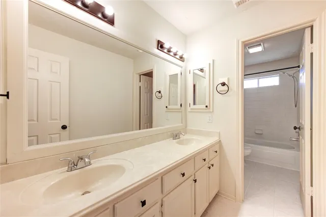 a bathroom with a double vanity sink mirror and double