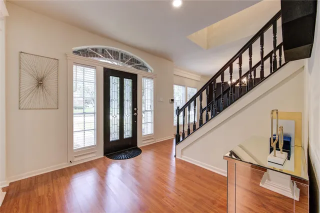 a view of entryway and hall with wooden floor