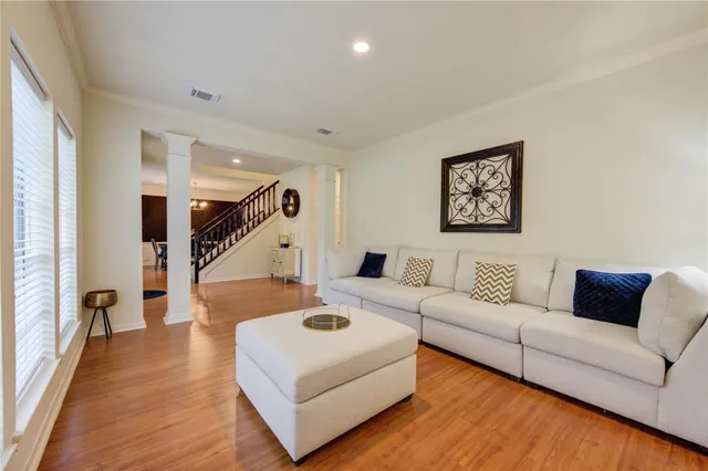 a living room with furniture and a wooden floor