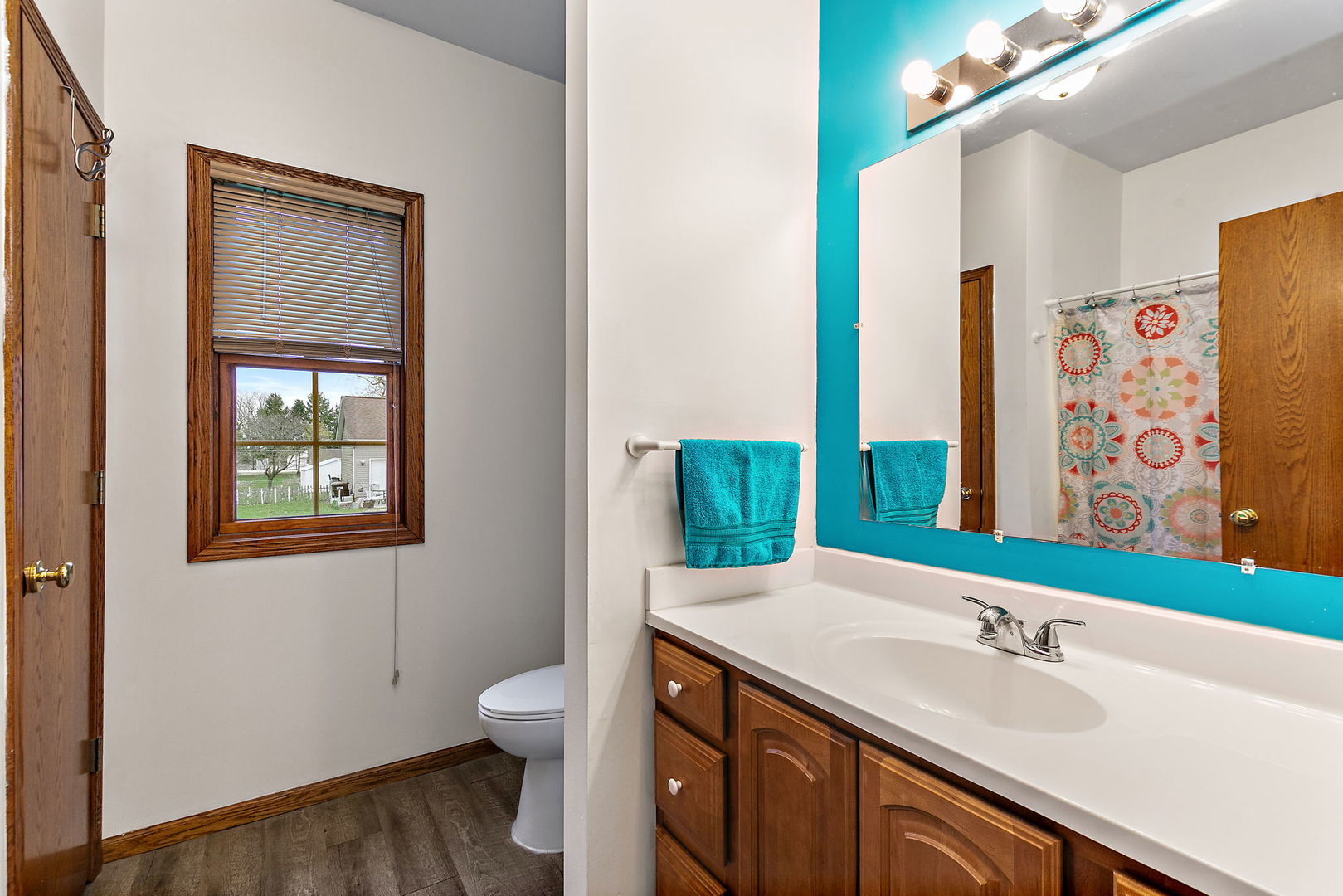 201 West Hardanger Gate Lee, IL 60530 - Photo 14 of 37 a bathroom with a granite countertop sink a toilet and a large mirror