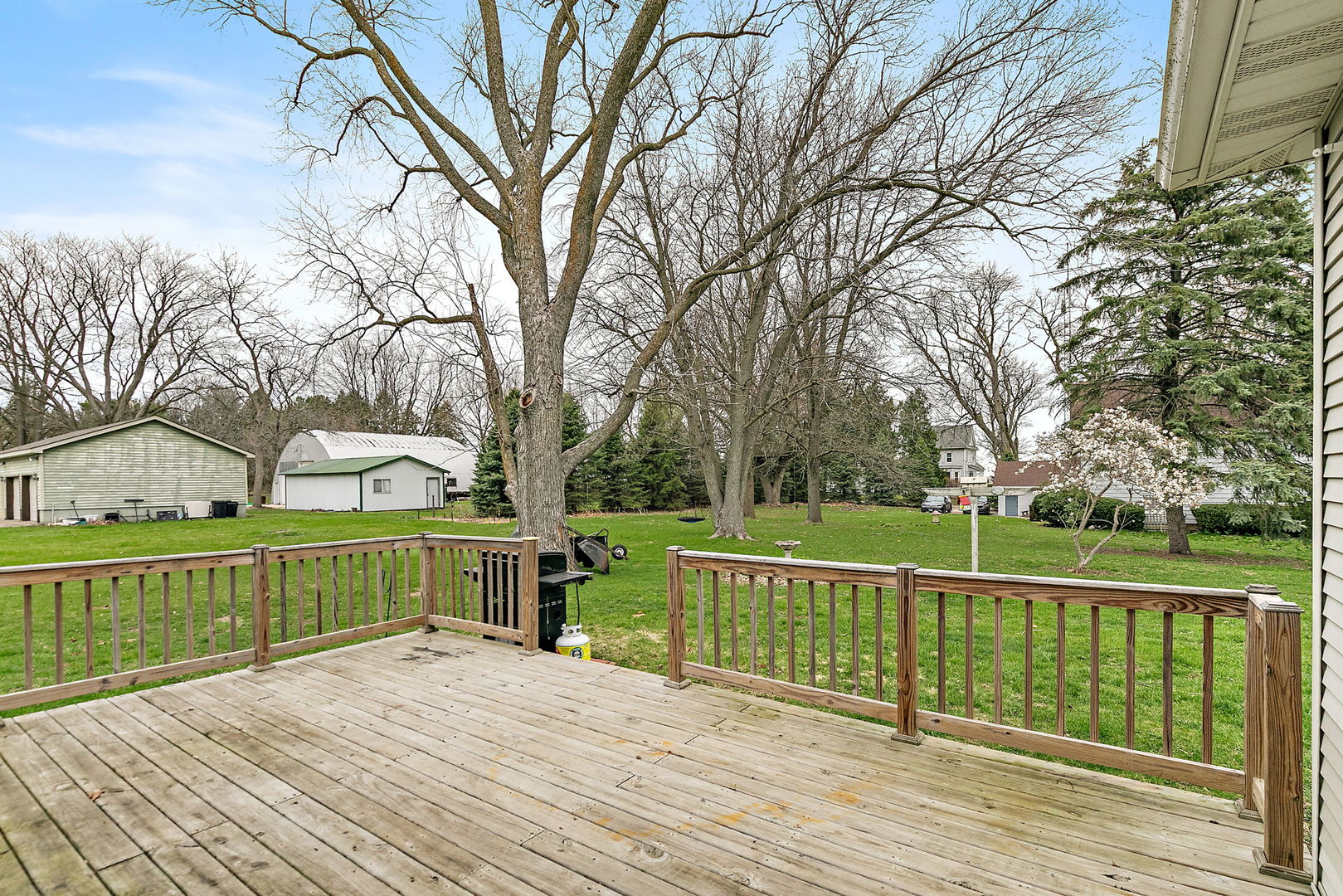 201 West Hardanger Gate Lee, IL 60530 - Photo 24 of 37 a view of a deck with large trees and wooden fence
