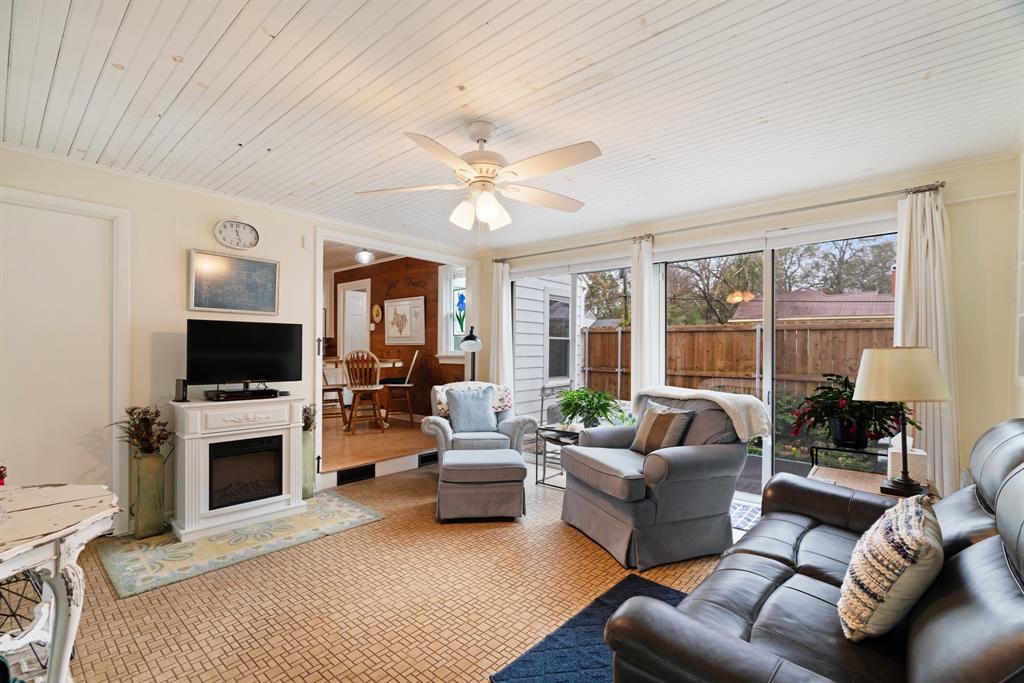2257 Cleveland Street Paris, TX 75460 - Photo 16 of 39 Living area with a ceiling fan, wood ceiling, a fireplace with raised hearth, and carpet floors