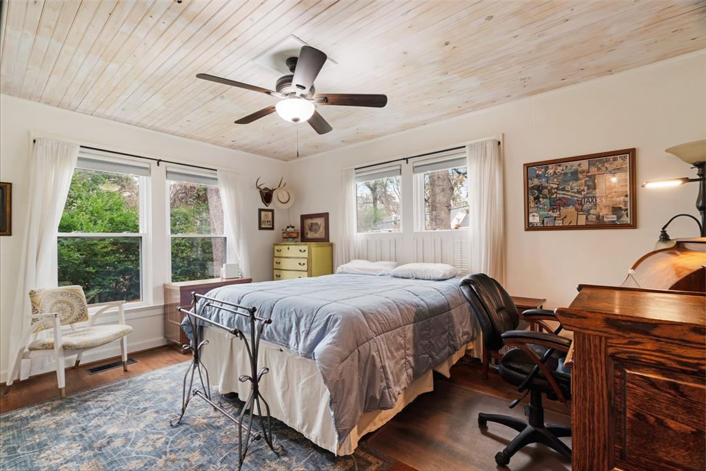 2257 Cleveland Street Paris, TX 75460 - Photo 17 of 39 Bedroom featuring wood finished floors, wood ceiling, ceiling fan, and a desk