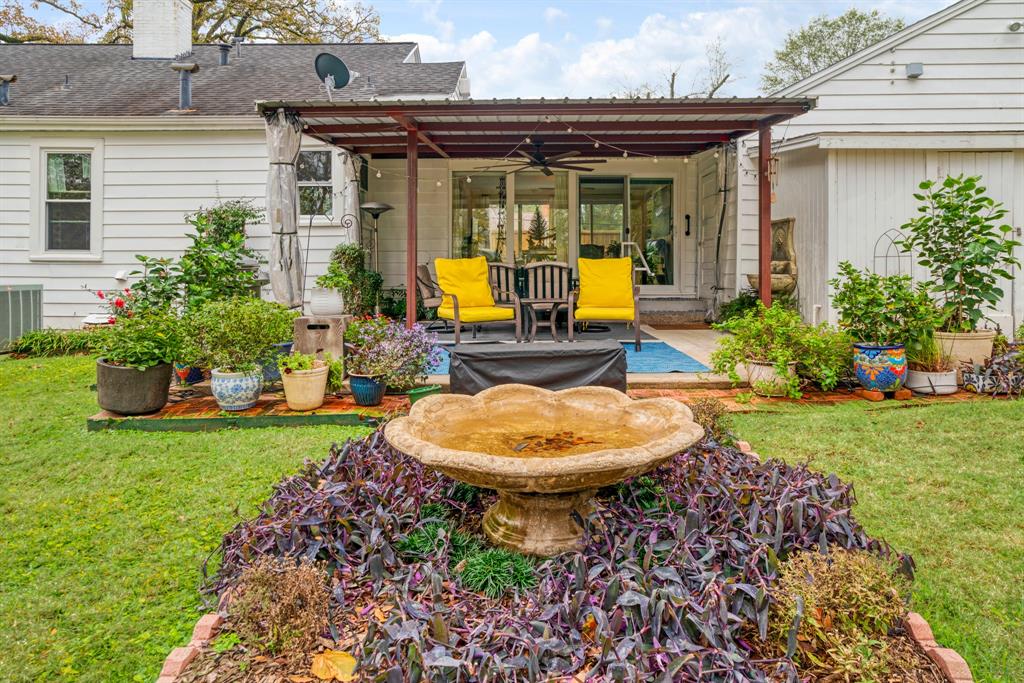 2257 Cleveland Street Paris, TX 75460 - Photo 21 of 39 Back of house featuring a ceiling fan, a yard, a patio area, a chimney, and roof with shingles