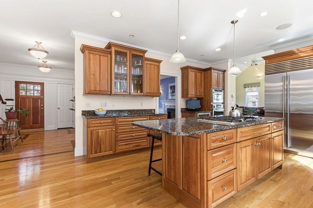 228 Mossman Road Sudbury, MA 01776 - Photo 11 of 42 a kitchen with stainless steel appliances granite countertop a stove a sink and a refrigerator