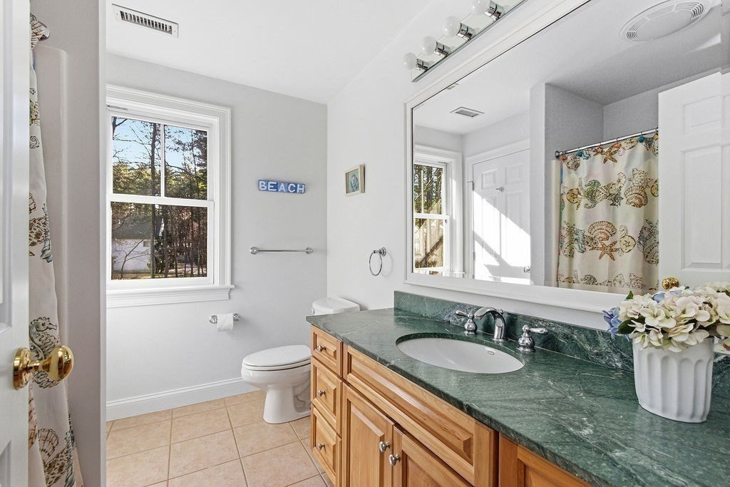 228 Mossman Road Sudbury, MA 01776 - Photo 36 of 42 a bathroom with a granite countertop sink and a window