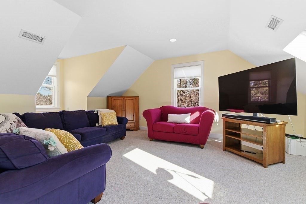 228 Mossman Road Sudbury, MA 01776 - Photo 38 of 42 a living room with furniture and a flat screen tv