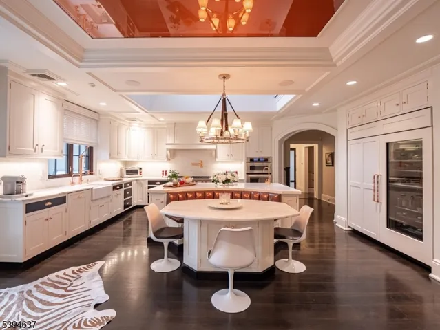 a kitchen with a dining table chairs stove and cabinets