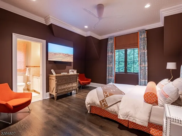 a bedroom with furniture and a large window