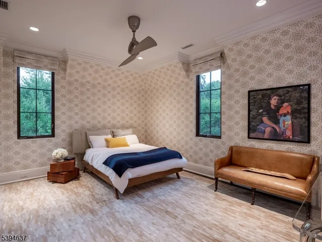 a spacious bedroom with a bed a couch and a window