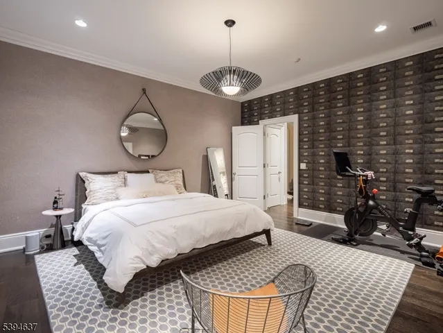 a bedroom with bed and wooden floor