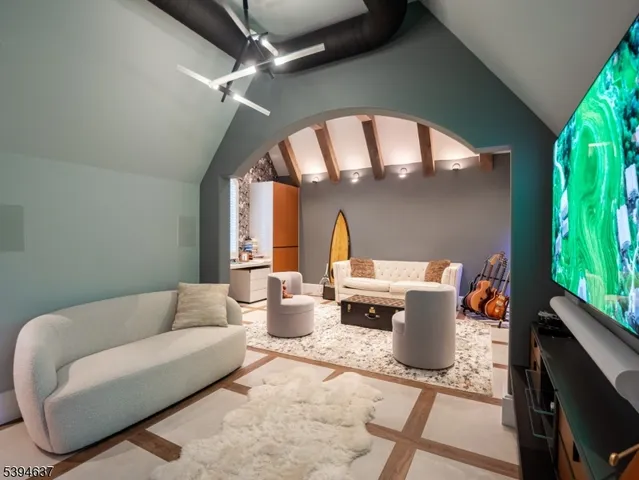 a living room with patio furniture and a potted plant