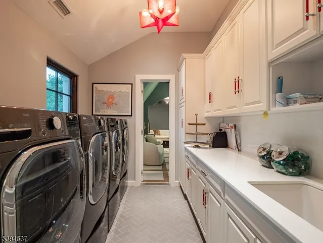 a kitchen that has a sink and a washer dryer