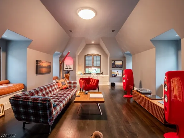 a bedroom with furniture and wooden floor