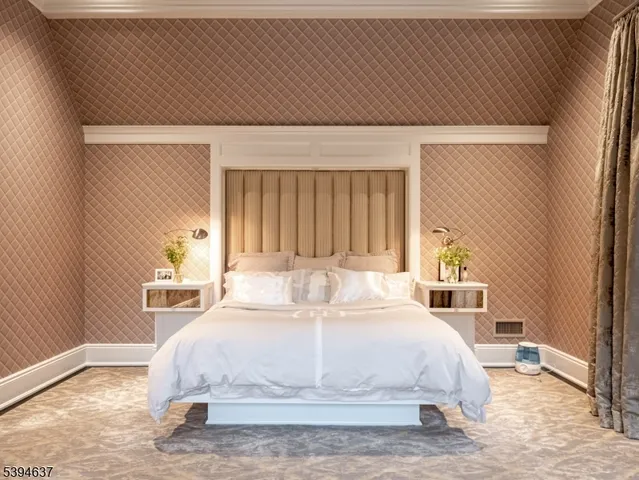 a large bed sitting in a bedroom next to a window and a lamp