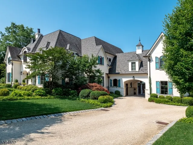 a front view of a house with a garden and plants