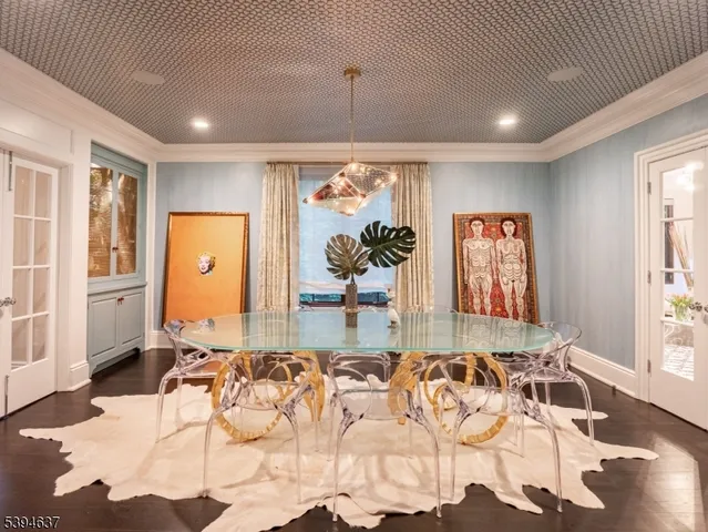 a living room with furniture windows and a potted plant