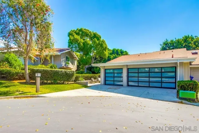 a view of a house with a yard and garage