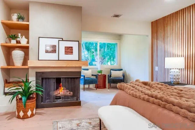 a bedroom with two beds and painting on the wall