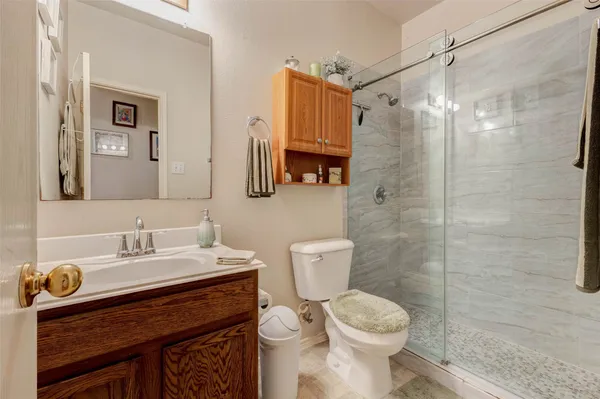 a bathroom with a sink toilet and shower