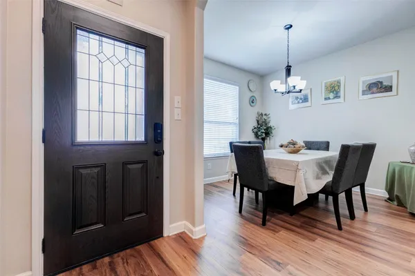 a view of a dining room with furniture wooden floor and chandelier