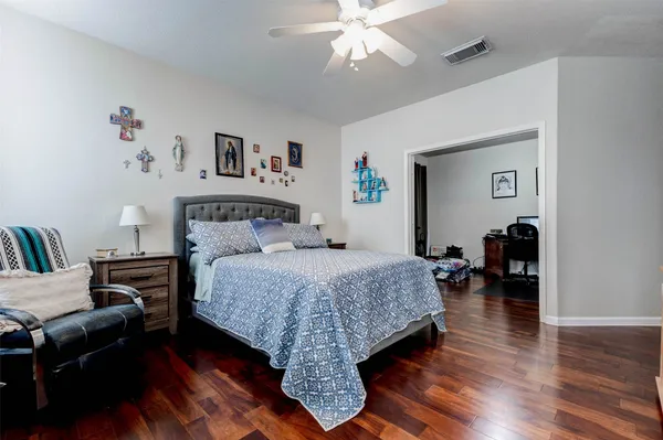 a bedroom with a bed and a chandelier