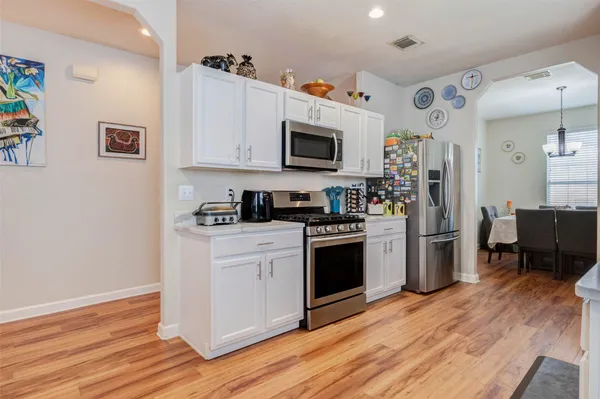 a kitchen with stainless steel appliances a refrigerator stove and microwave