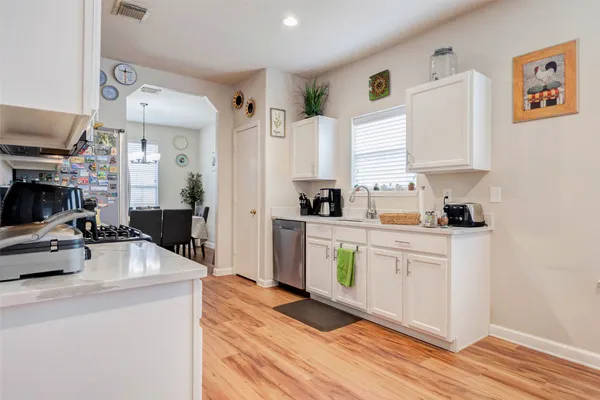 a kitchen with stainless steel appliances a stove a sink and a refrigerator