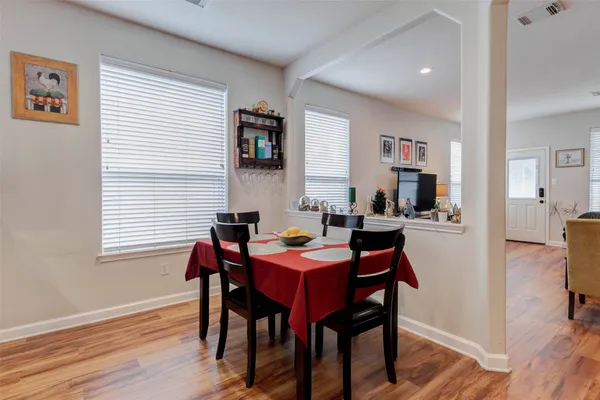 a view of a dining room with furniture and wooden floor