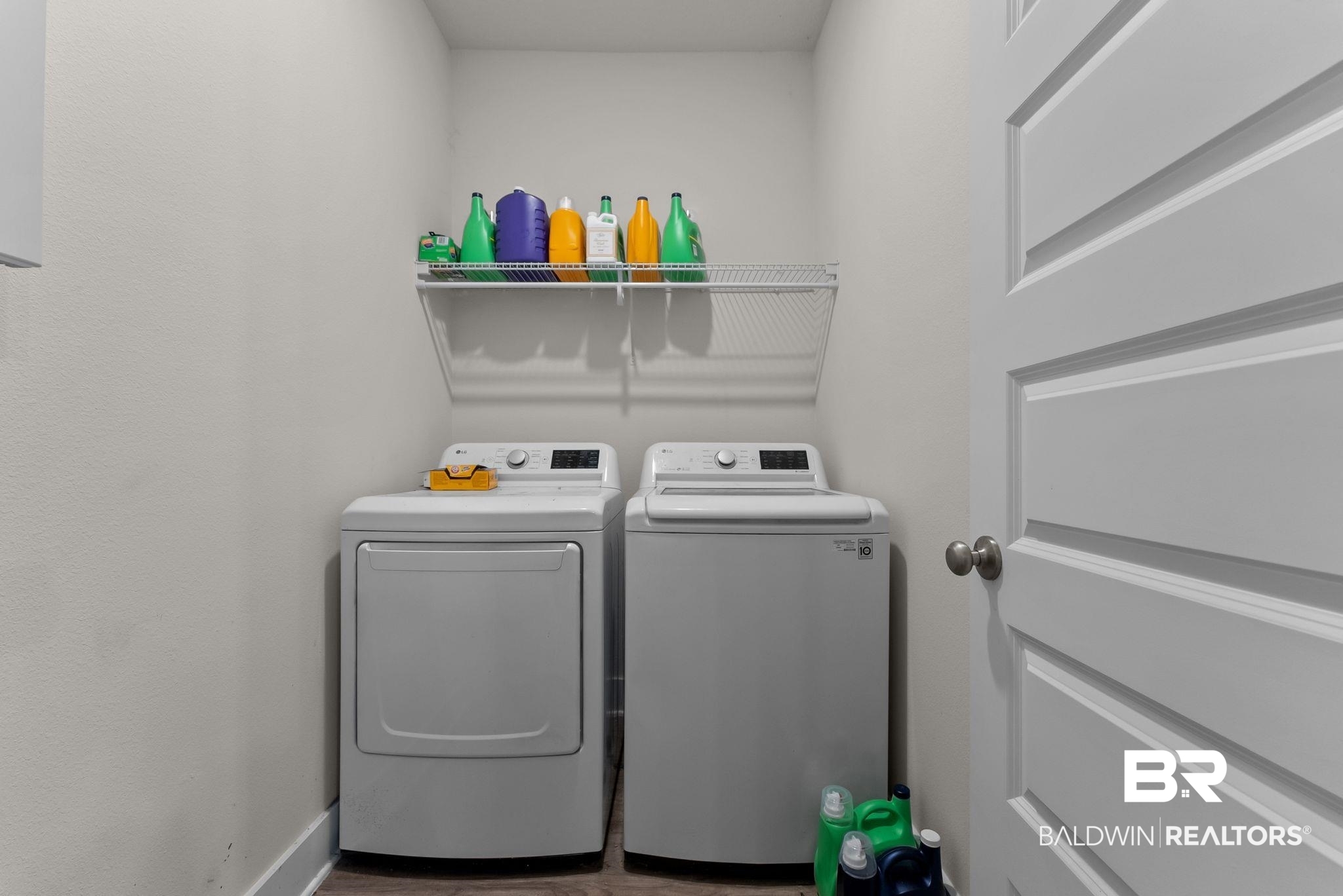 16607 Prado Loop Loxley, AL 36551 - Photo 39 of 46 Dedicated laundry area featuring a white wire shelving unit above laundry appliances