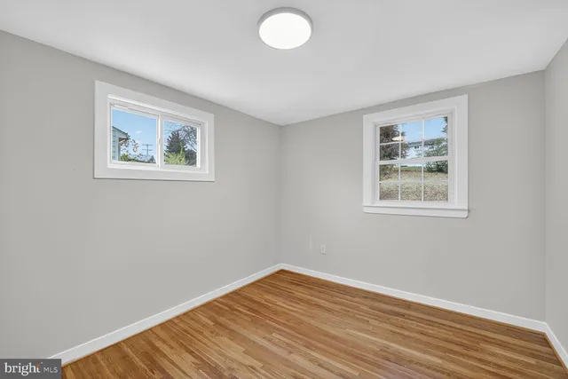 a view of a room with wooden floor and window