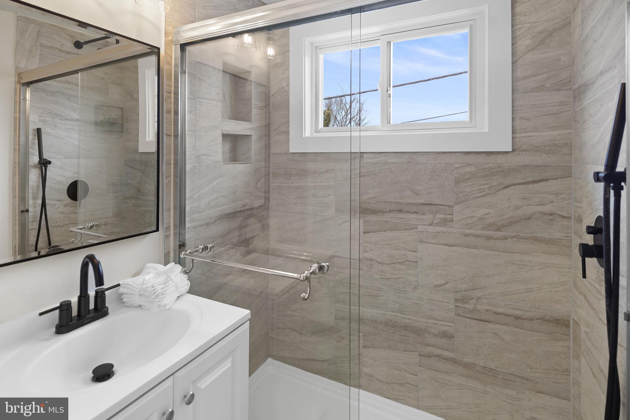 404 Kerby Hill Road Fort Washington, MD 20744 - Photo 14 of 24 a bathroom with a shower sink and mirror