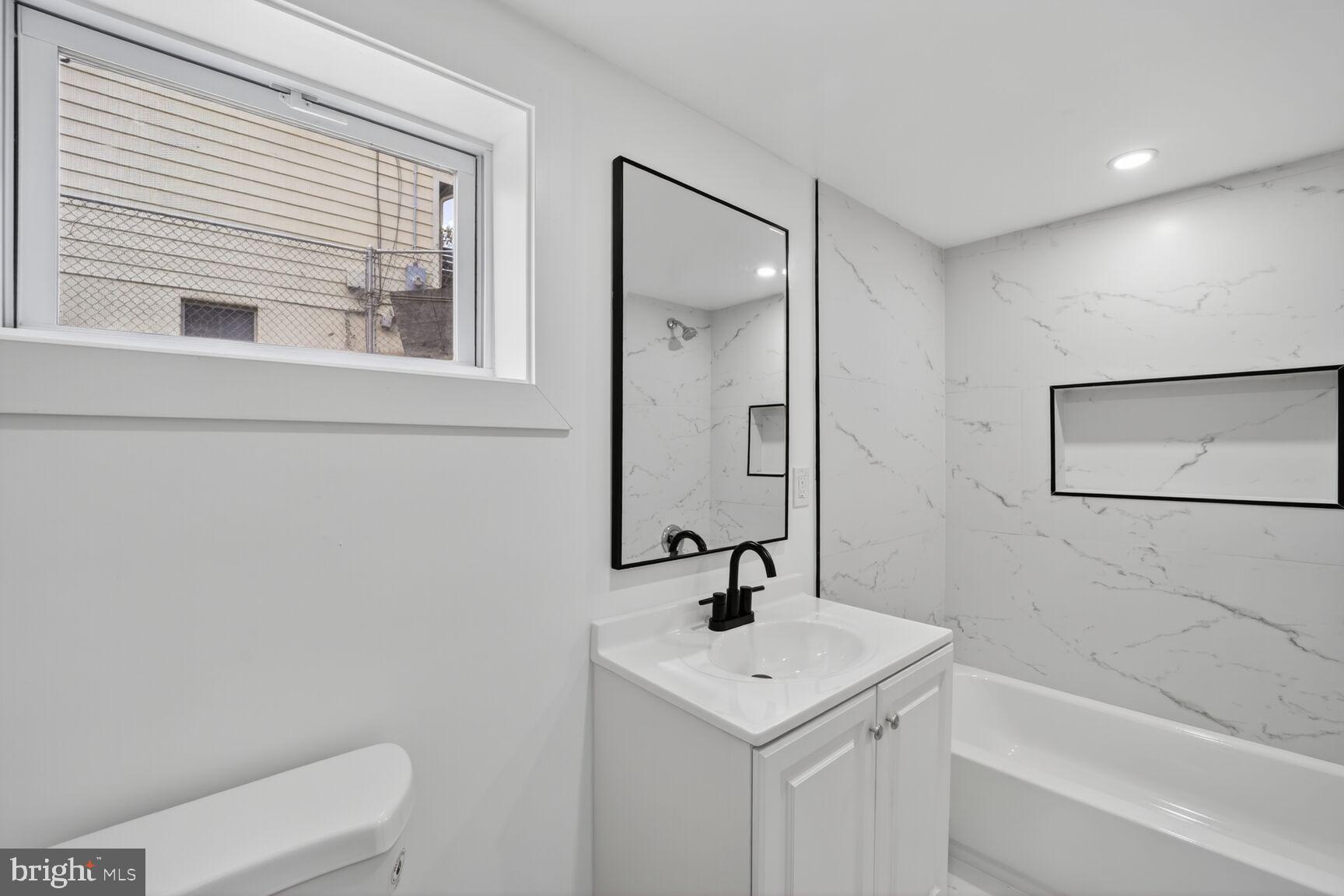 404 Kerby Hill Road Fort Washington, MD 20744 - Photo 15 of 24 a bathroom with a sink a toilet and a bathtub