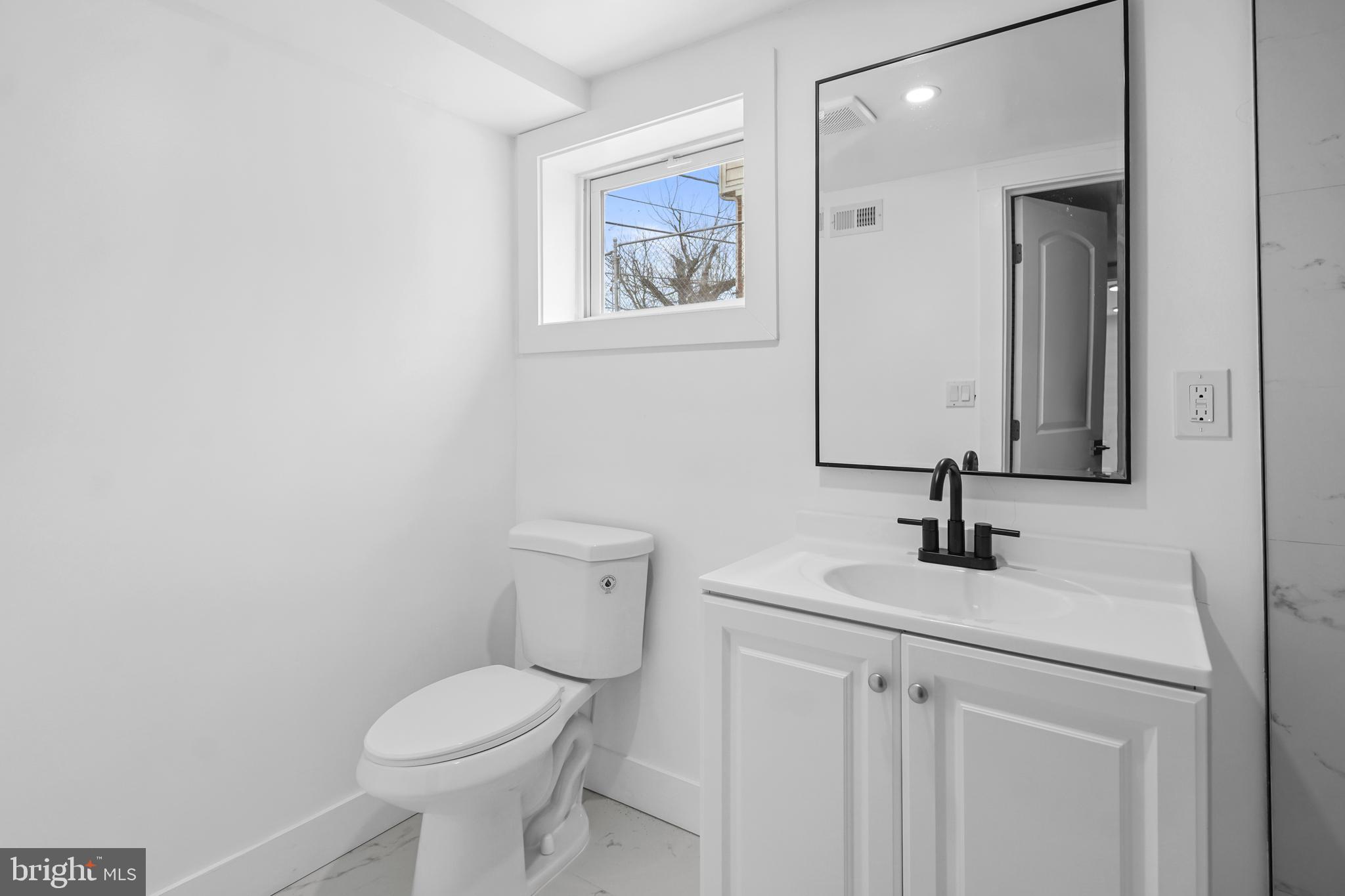 404 Kerby Hill Road Fort Washington, MD 20744 - Photo 16 of 24 a bathroom with a toilet sink and mirror