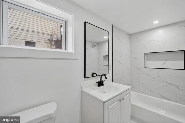 a bathroom with a sink a toilet and a bathtub