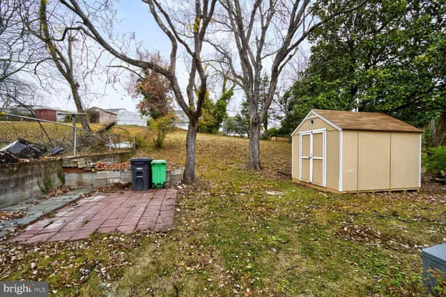 a view of a house with a large tree and a yard