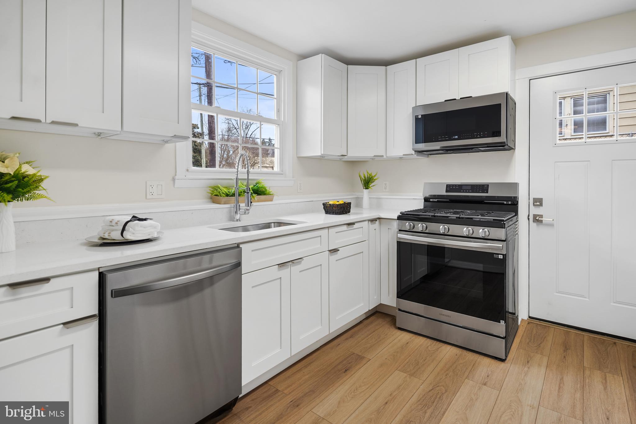 404 Kerby Hill Road Fort Washington, MD 20744 - Photo 4 of 24 a kitchen with stainless steel appliances white cabinets a sink and a stove