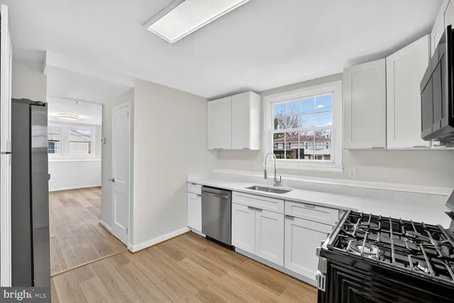 a kitchen with a stove a sink and a refrigerator