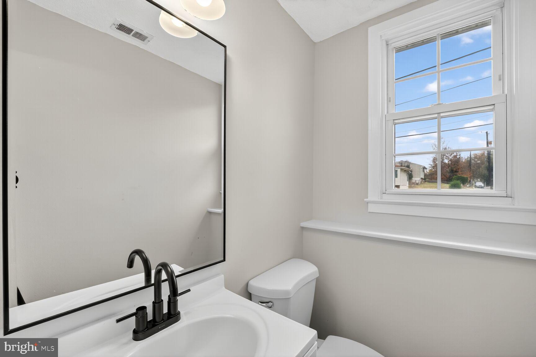 404 Kerby Hill Road Fort Washington, MD 20744 - Photo 6 of 24 a bathroom with a toilet and a sink