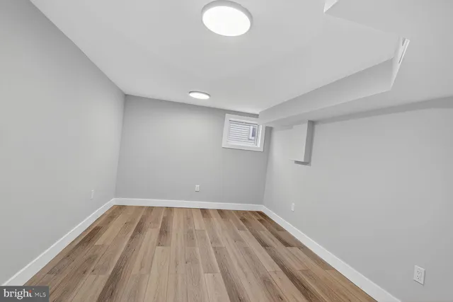 a view of room with wooden floor and fan