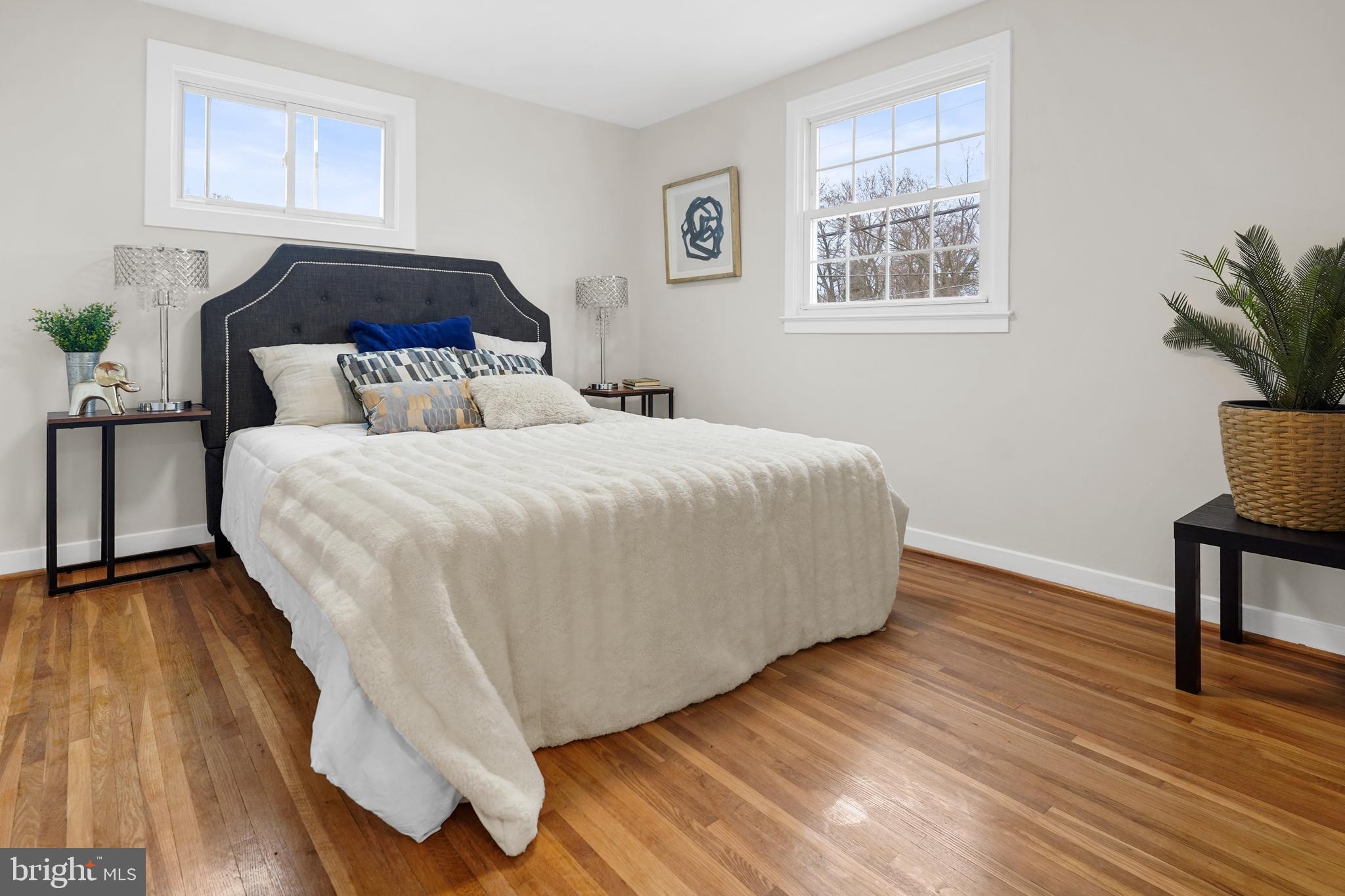 404 Kerby Hill Road Fort Washington, MD 20744 - Photo 10 of 24 a large bed sitting in a bedroom next to a window with potted plant