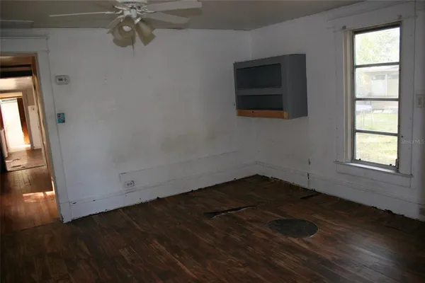a kitchen with granite countertop a stove a sink and a refrigerator