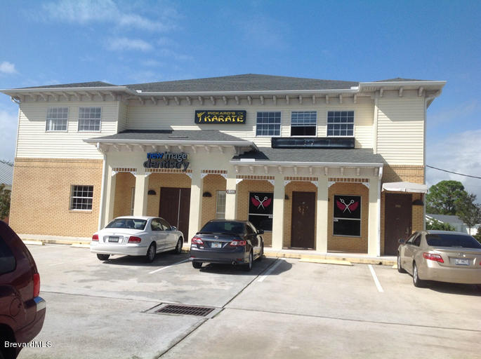 5132 Minton Road, Unit 6 Palm Bay, FL 32907 - Photo 1 of 15 a building with car parked in front of it
