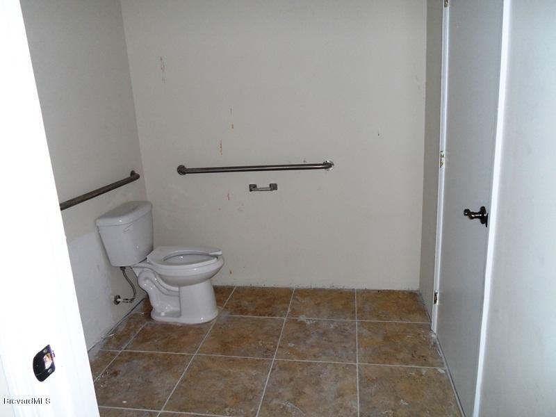 5132 Minton Road, Unit 6 Palm Bay, FL 32907 - Photo 13 of 15 a bathroom with a toilet and a shower
