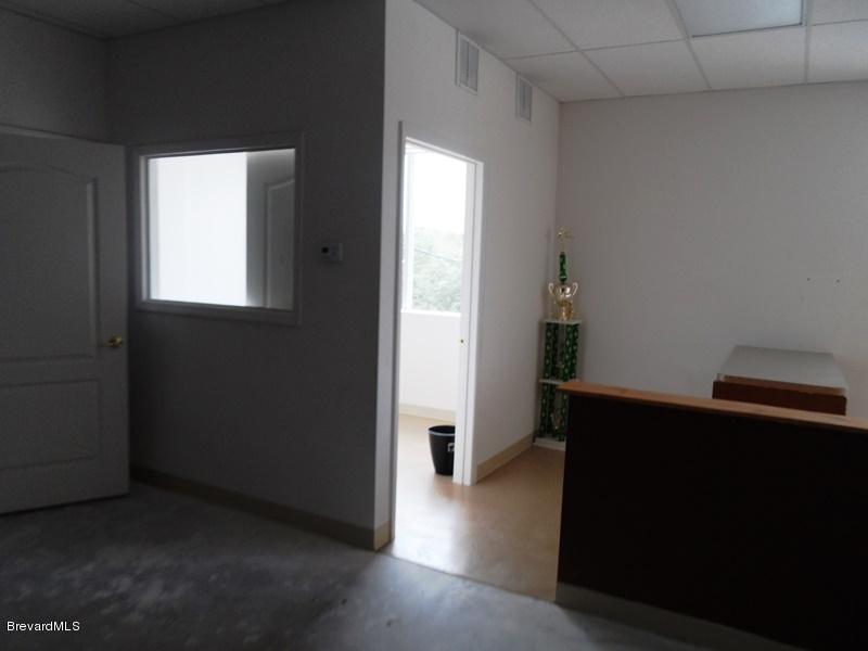 5132 Minton Road, Unit 6 Palm Bay, FL 32907 - Photo 6 of 15 a view of an empty room with wooden floor and a window