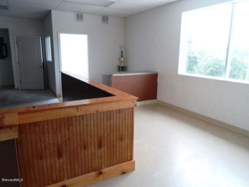 5132 Minton Road, Unit 6 Palm Bay, FL 32907 - Photo 8 of 15 a view of an empty room with wooden floor and windows