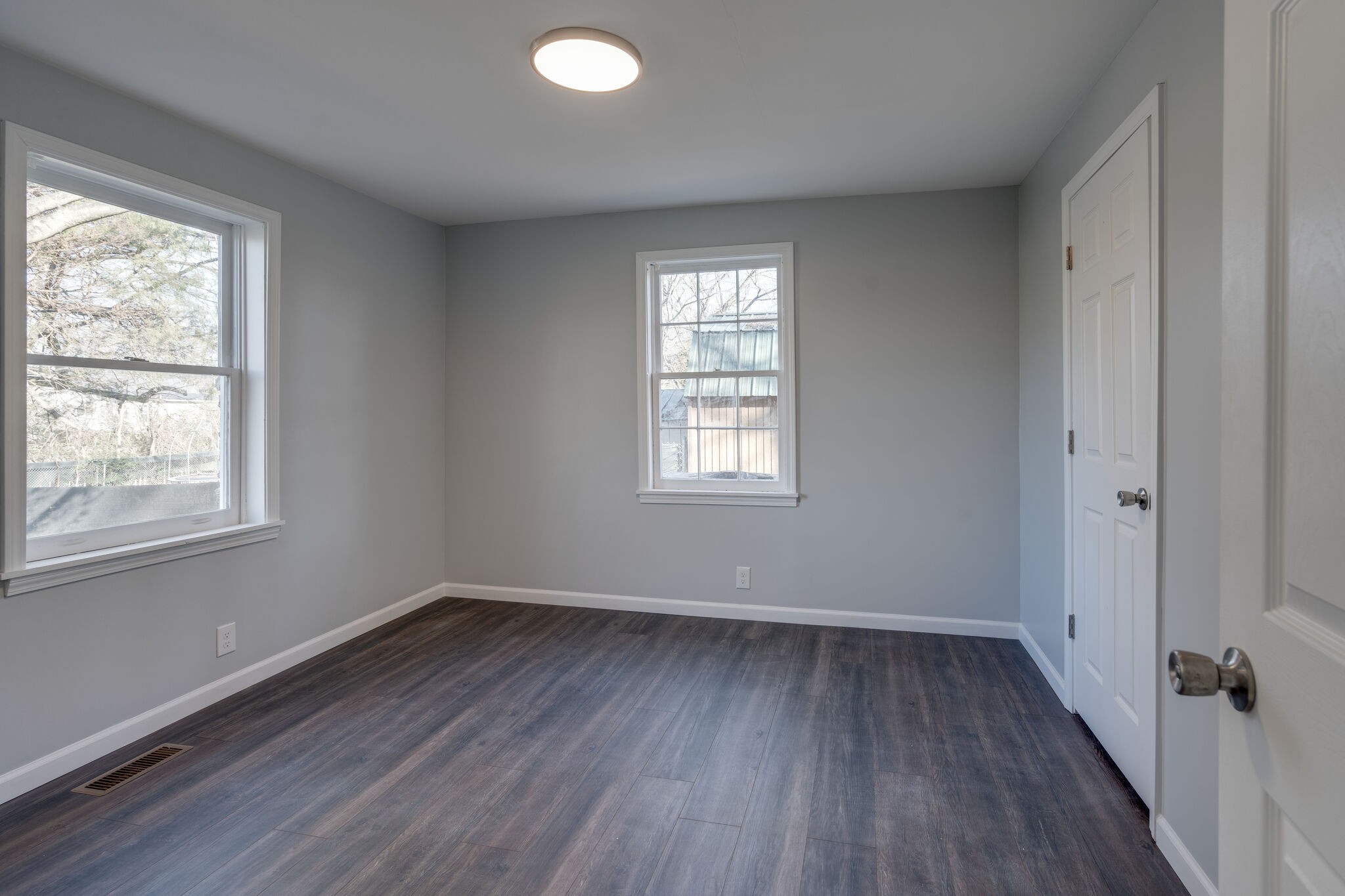 706 Pace Street Gallatin, TN 37066 - Photo 12 of 20 an empty room with wooden floor and windows