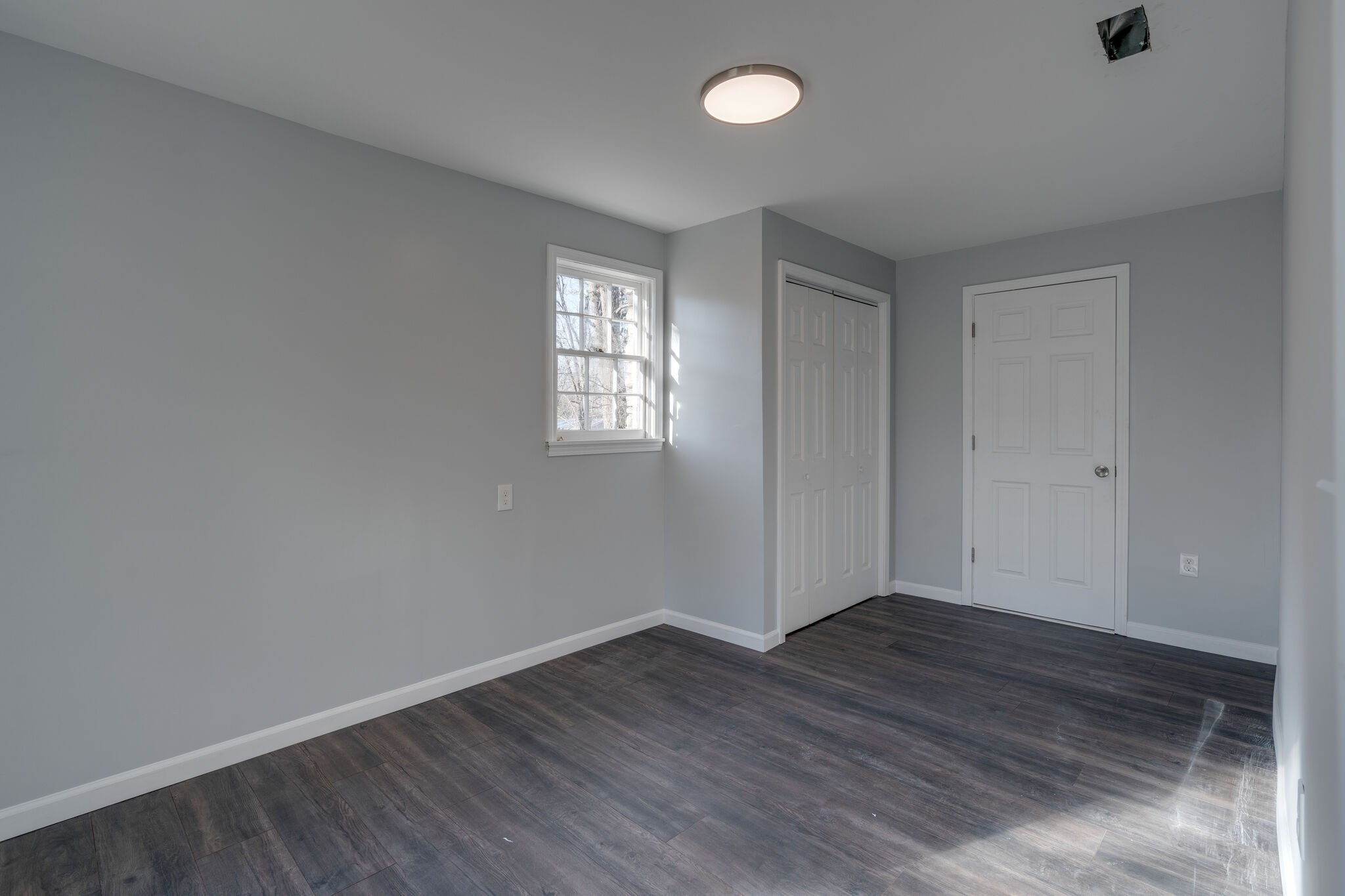 706 Pace Street Gallatin, TN 37066 - Photo 16 of 20 an empty room with wooden floor and windows