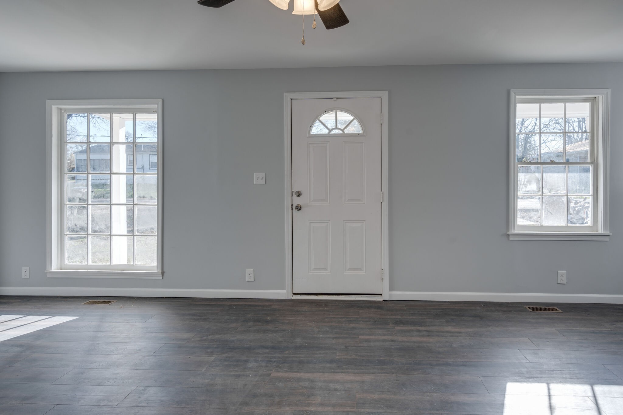 706 Pace Street Gallatin, TN 37066 - Photo 4 of 20 an empty room with wooden floor and windows
