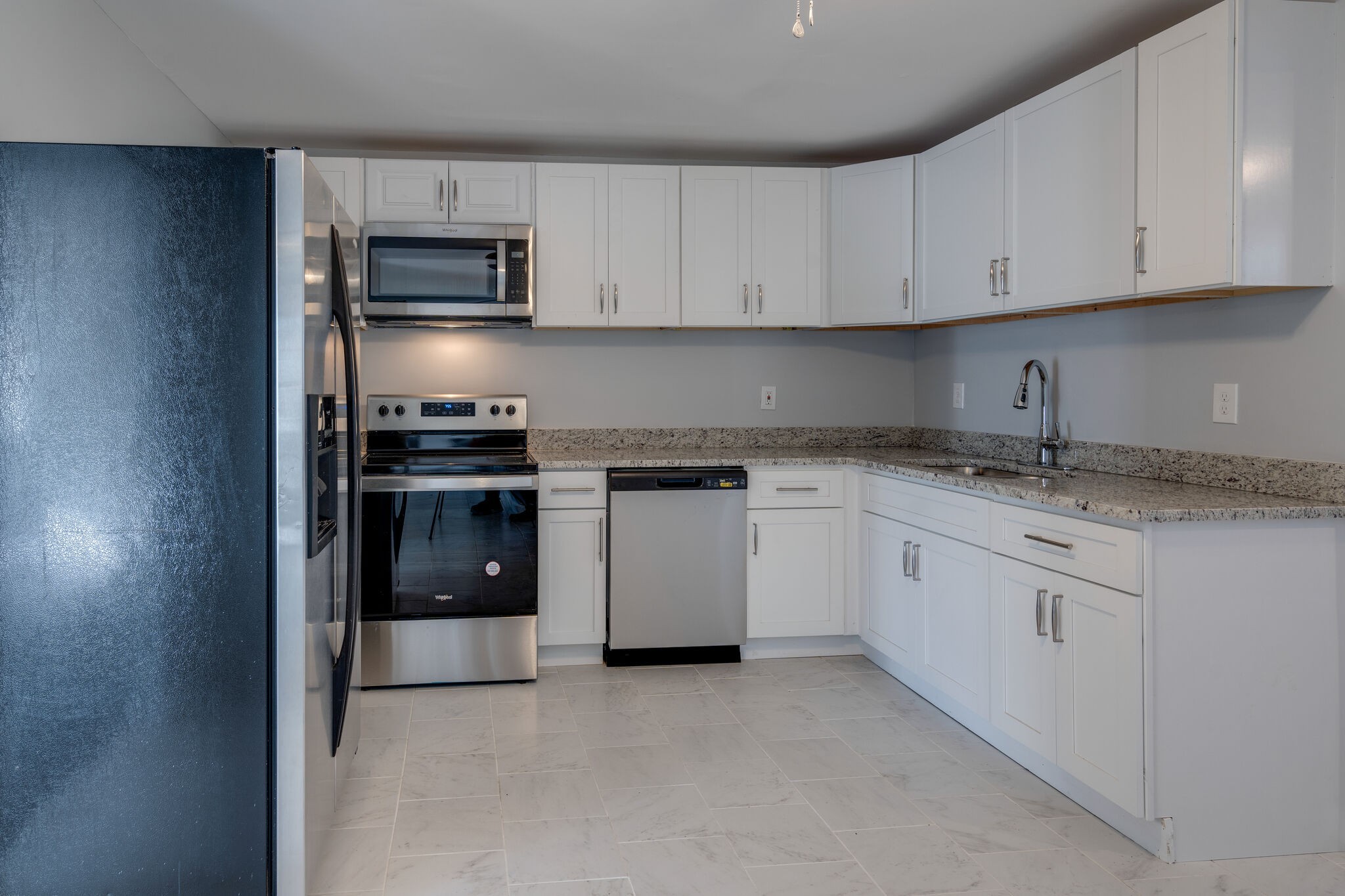 706 Pace Street Gallatin, TN 37066 - Photo 6 of 20 a kitchen with granite countertop white cabinets and stainless steel appliances